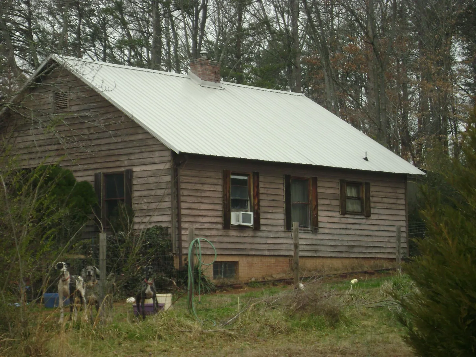 White metal roof on an old wood sided farmhouse, from a Metal Roof Installation job in Crawfordville